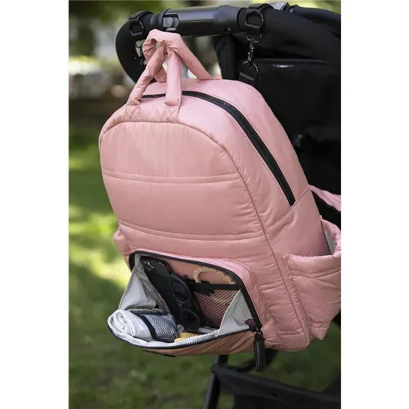 Diaper backpack in Rose Dawn, featuring multiple compartments and a front pocket storing essentials like sunglasses and a blanket.