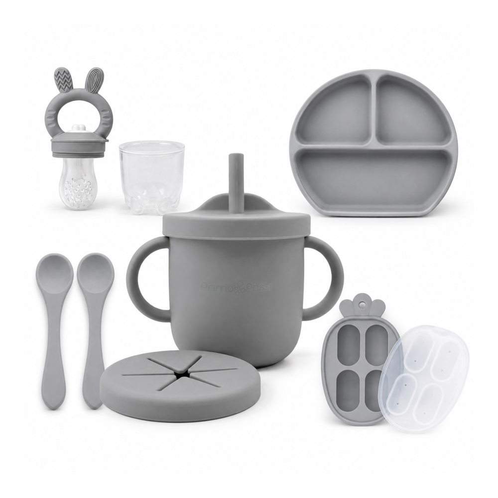 Primo Passi grey silicone baby feeding set with suction bowl, plate, cups, and spoons.