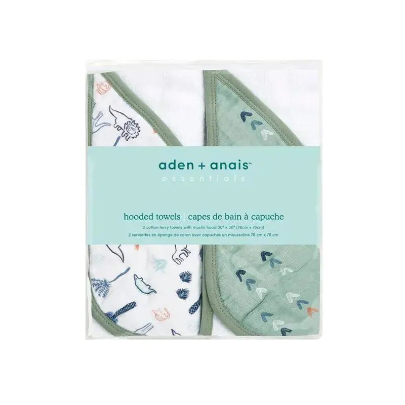 Cotton muslin hooded towels by Aden + Anais featuring a dinosaur design and a green patterned towel, packaged together.