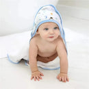 Hooded baby towel in blue and white, featuring space-themed designs, with a baby seated on a light floor.