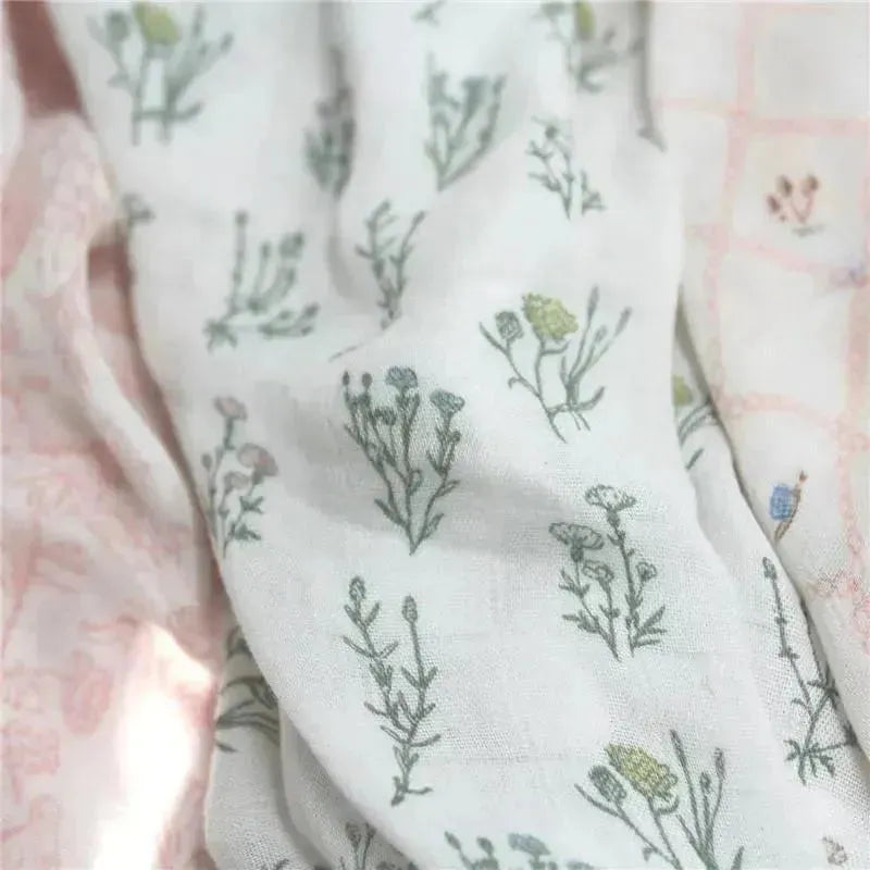 Silky soft Aden + Anais 3-pack swaddles featuring floral patterns in pastel colors on lightweight fabric.