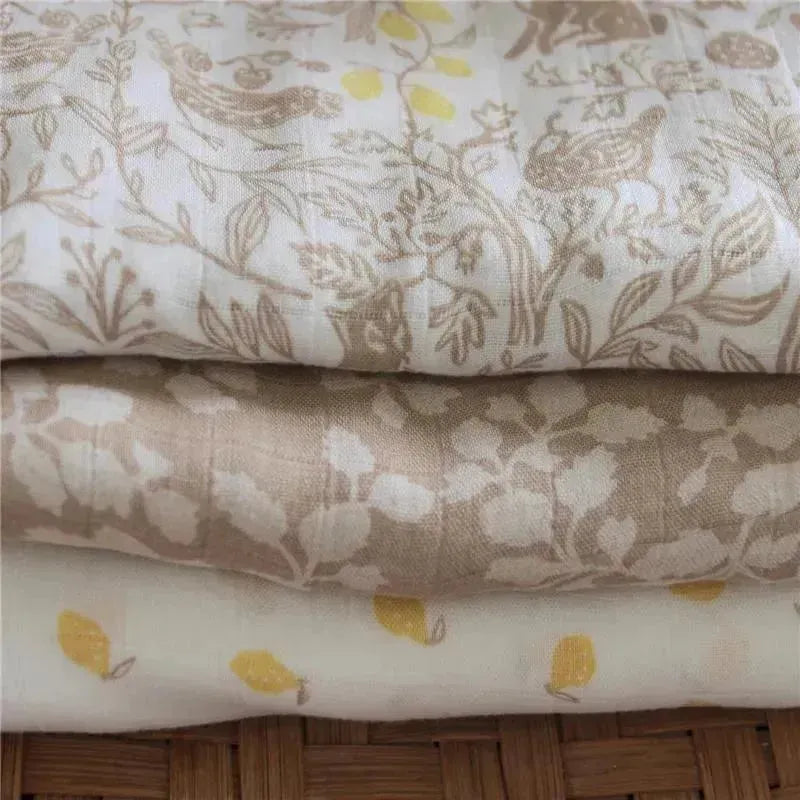 Aden + Anais 3-pack swaddles featuring soft, natural fabrics with woodland and floral patterns in pastel colors.