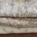 Aden + Anais 3-pack swaddles featuring soft, natural fabrics with woodland and floral patterns in pastel colors.