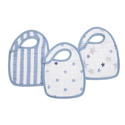 Three Aden + Anais snap bibs in blue tones featuring striped, polka dot, and star patterns designed for infants.