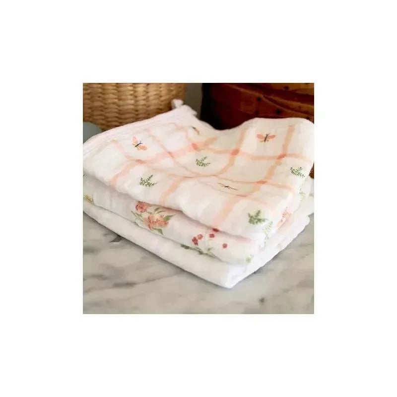 Classic washcloth set featuring three soft, floral-patterned towels stacked neatly on a marble surface.