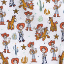 Toy Story-themed fabric featuring characters such as Woody and Jessie, with western motifs and cacti.