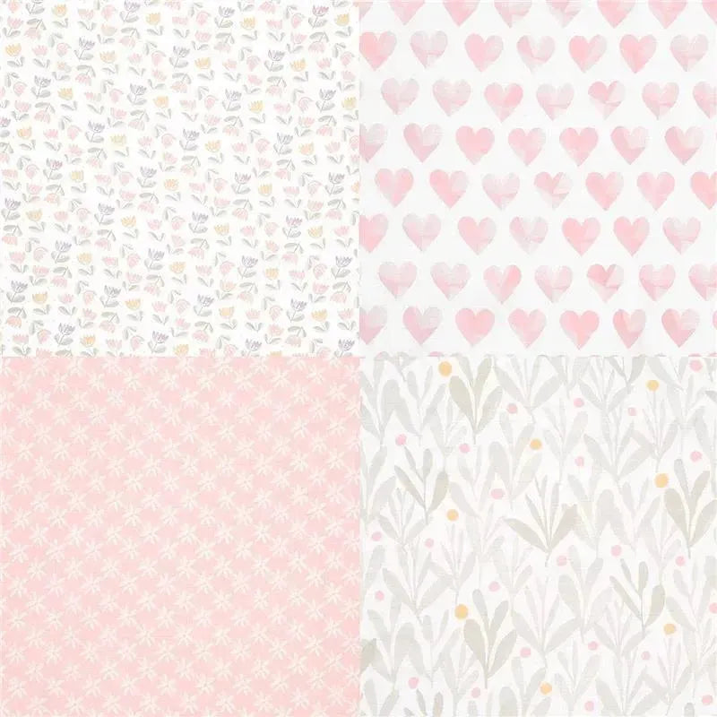 Four muslin swaddles featuring pastel designs: floral prints, hearts, and dotted patterns.