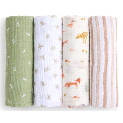 Four cotton muslin swaddles in sage green, white with bird prints, cream with forest animals, and beige stripes.
