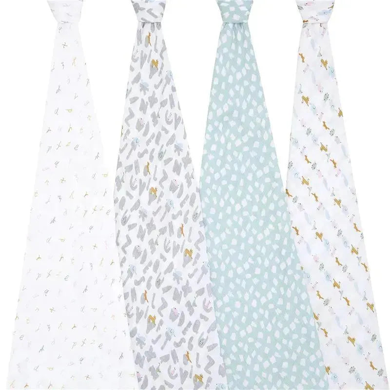 Muslin swaddles from Aden + Anais featuring four different designs, including alphabet letters and animal patterns.