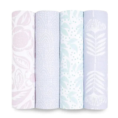 Four rolled muslin swaddles from Aden + Anais in pastel colors featuring floral and leaf patterns.
