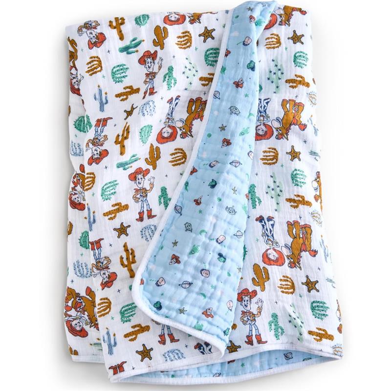 Cotton muslin blanket featuring Toy Story characters, including Woody, with colorful cacti and stars on a white background.