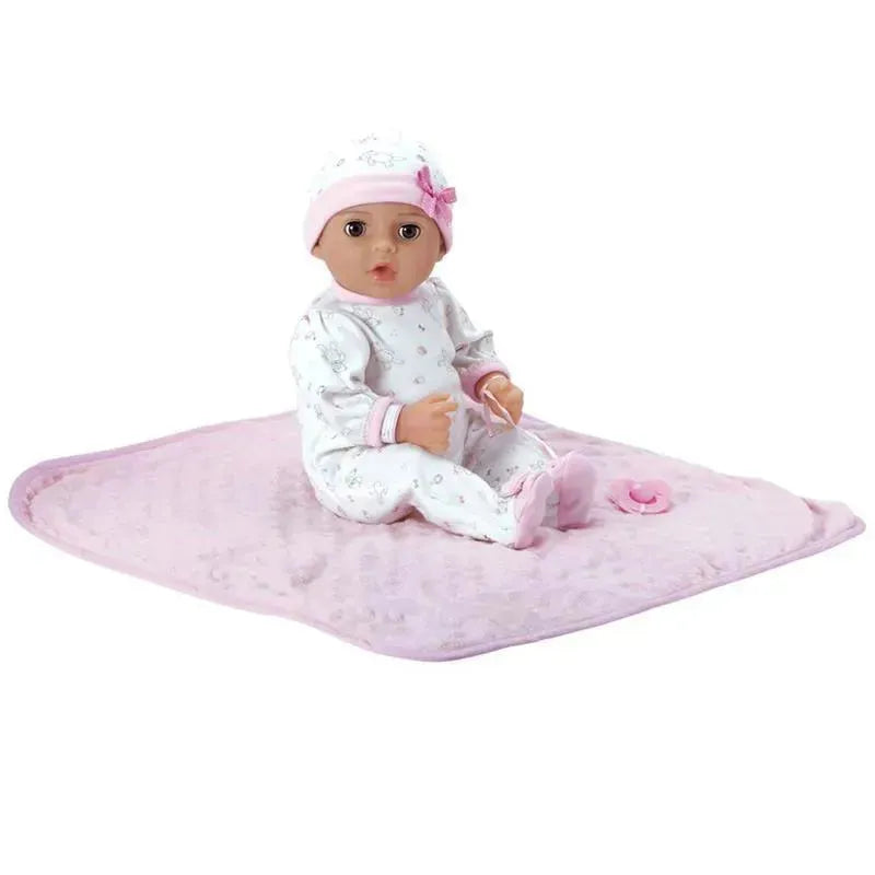 Adoption baby doll named Cherish, wearing a floral onesie and pink hat, sitting on a soft pink blanket with a pacifier.