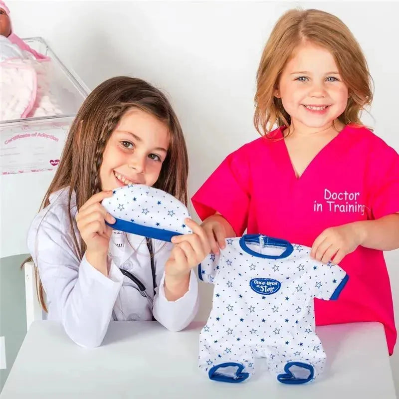 Two young girls showcase the Adora Adoption Fashion play outfit, featuring a white star-patterned onesie and matching hat.