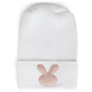 White hospital hat featuring a blush pink woven bunny design. Ideal for newborns.