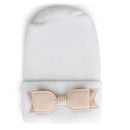 Newborn hospital hat in white with a soft, petal bow detail at the base. Ideal gift for baby girls.