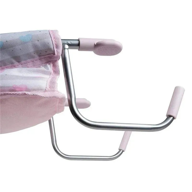 Pastel pink feeding seat for dolls, featuring a sturdy metal frame and soft fabric, designed for imaginative play.