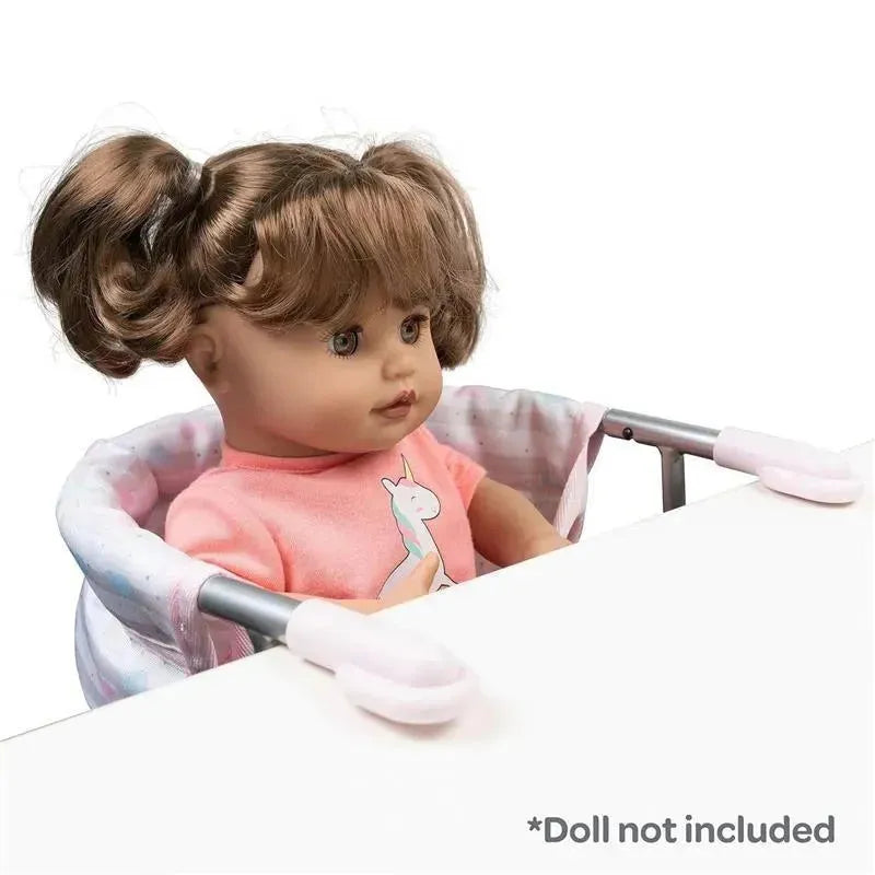 Pastel pink feeding seat for dolls, featuring a removable soft padded insert with a unicorn design. Doll not included.