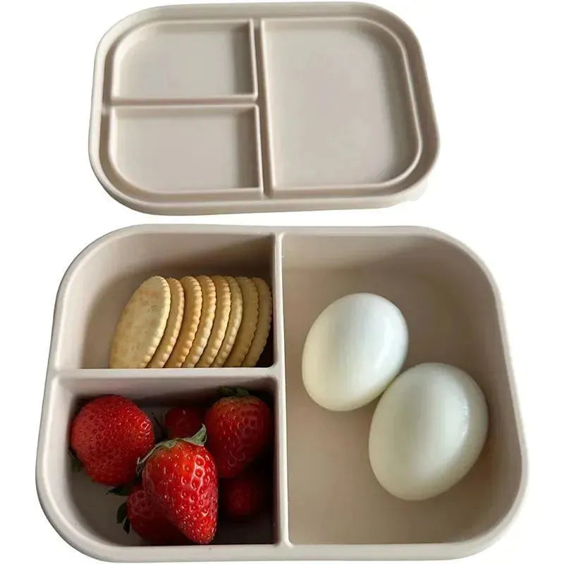 Leakproof silicone bento box in Coco color, featuring compartments with strawberries, cookies, and boiled eggs.
