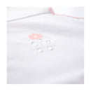 Long sleeve smock bib in white with pink flower design and water droplets, showcasing its waterproof feature.