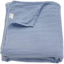 Soft, folded muslin swaddle blanket in Dream Blue, featuring a wrinkled texture and ali + oli label.