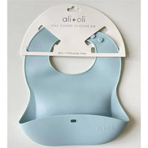 Ali+Oli silicone baby bib in sky blue, designed to roll up and stay closed, BPA and phthalate free.