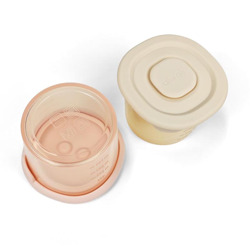 Silicone food containers in blush and khaki colors, 4 oz size, with measurement markings visible.