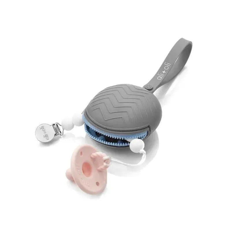 Grey silicone pacifier case featuring a zipper and a clip, with a pink pacifier placed beside it.