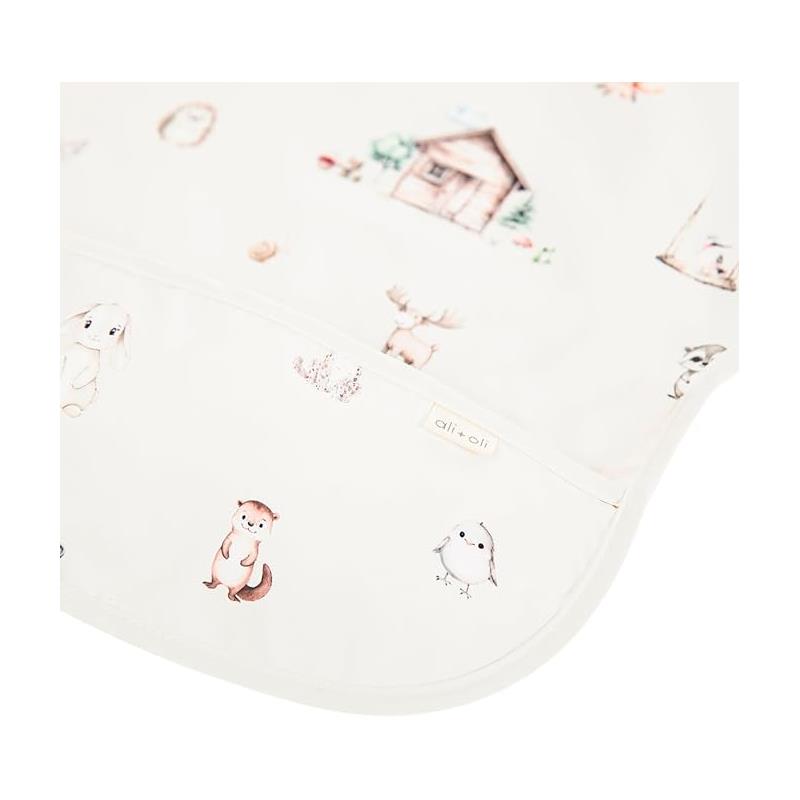 Smock bib for babies and toddlers featuring a woodland animal print with illustrations of a house and various cute animals.
