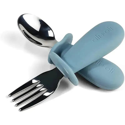 Toddler learning set including a powder blue spoon and fork with ergonomic handles for easy grip.