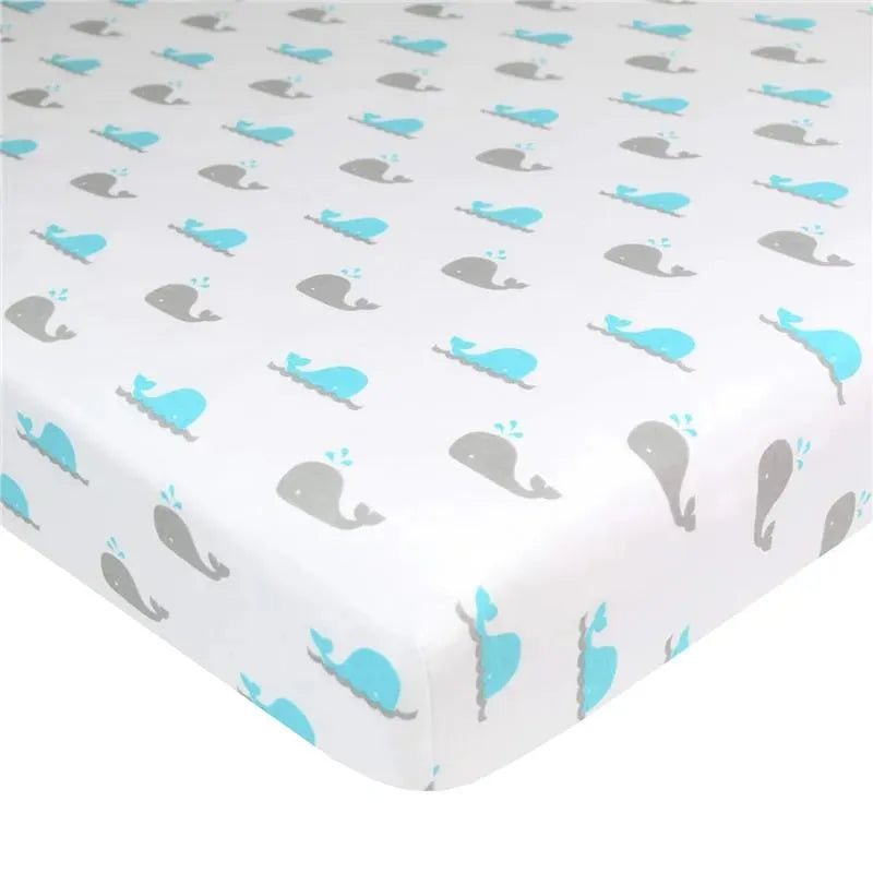 Grey and blue whale patterned fitted bassinet sheet, made of 100% cotton jersey, measuring 15 x 33 x 4 inches.