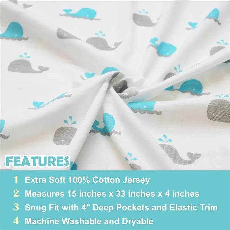 Grey bassinet sheet made of 100% cotton jersey, featuring a whale pattern, measuring 15 x 33 x 4 inches.
