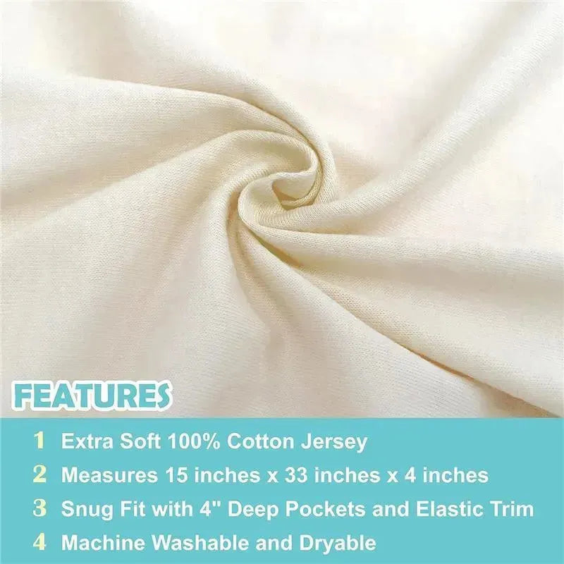 Cream-colored fitted bassinet sheet made from 100% natural cotton jersey knit, shown with features listed below.