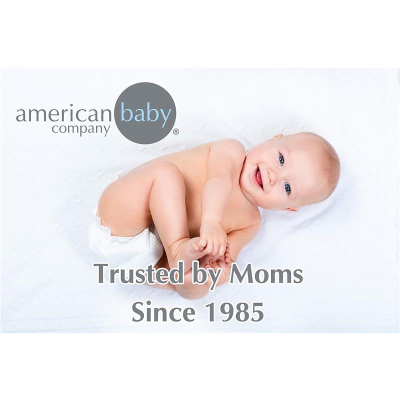 Blue thermal waffle swaddle blanket by American Baby Company, featuring a happy baby lying on a white surface.