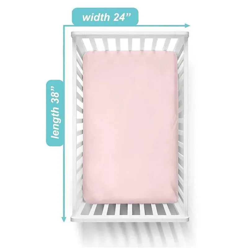 Fitted mini crib sheet in baby pink, made of 100% cotton jersey, displayed on a crib with measurements 24 x 38 inches.