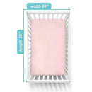 Fitted mini crib sheet in baby pink, made of 100% cotton jersey, displayed on a crib with measurements 24 x 38 inches.