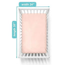 Fitted mini crib sheet in blush color, measuring 24 x 38 inches, made of 100% cotton jersey, placed in a white crib.