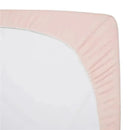 Fitted mini crib sheet in blush, 100% cotton jersey, with elastic edges for a secure fit.
