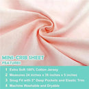 Blush-colored fitted mini crib sheet made of 100% cotton jersey, featuring snug fit with 5-inch deep pockets.