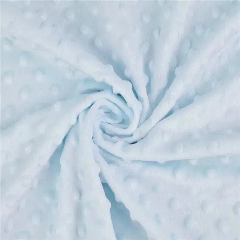 Soft blue chenille minky dot receiving blanket, featuring a textured dot pattern, elegantly spiraled for display.