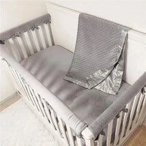 Heavenly Soft Chenille Minky Dot Receiving Blanket in Grey draped on a crib fitted with a matching gray bumper and liner.