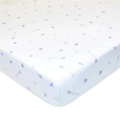 Fitted crib sheet featuring a blue arrow and triangle print on a white background, made from 100% cotton jersey knit.