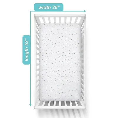 Fitted crib sheet in blue with arrow pattern, measuring 28” width by 52” length, inside a white crib.