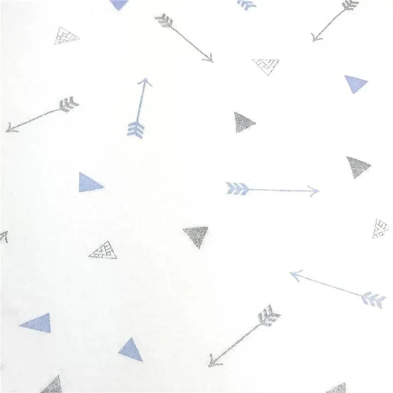 Fitted crib sheet featuring a pattern of blue and gray arrows and triangles on a white background.