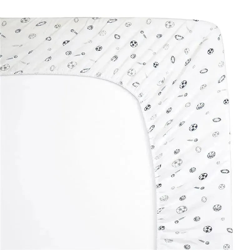 Grey fitted crib sheet with printed sports motifs, including soccer balls, basketballs, and baseballs on soft cotton.