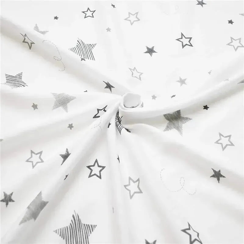 100% cotton fitted crib sheet featuring a white background with various gray stars and stripes designs.