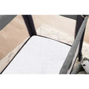 Waterproof Pack N Play mattress protector displayed inside a playard, featuring a quilted white surface.
