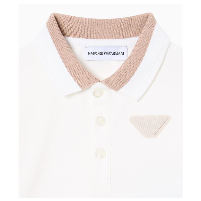 Short sleeve white polo shirt for baby boys featuring a beige collar and logo detail.