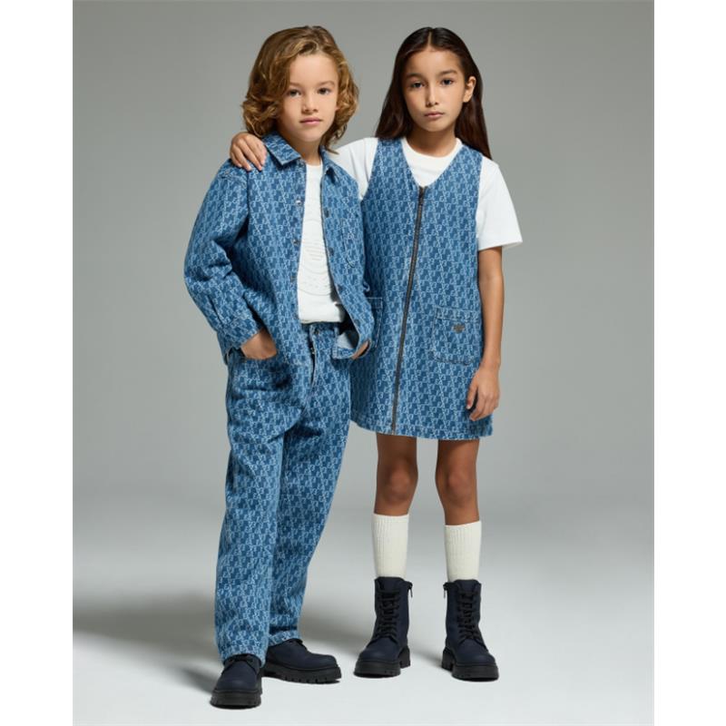 Denim jersey dress for girls featuring an all-over logo design in blue, worn by a girl with a coordinating outfit beside her.