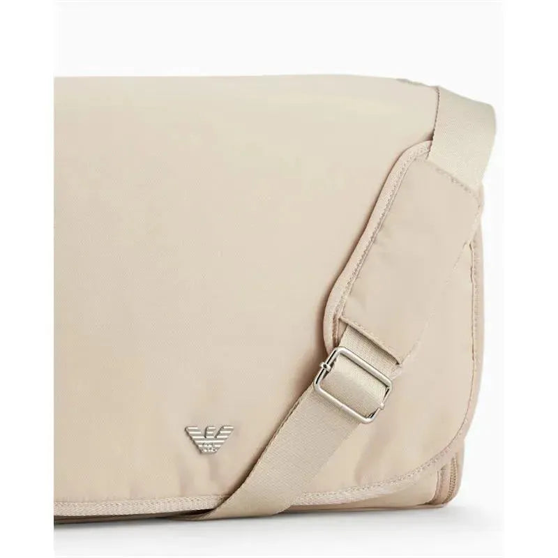 Beige Armani Baby mummy bag featuring an adjustable strap and a silver eagle logo on the front.