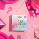 Gender reveal cotton candy glitter bombs by Art of Sucre, featuring pink packaging and decorative elements on a pink background.